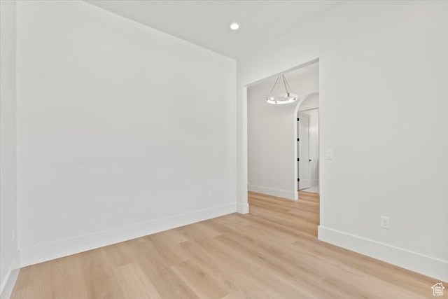 1065 W 125 S, Lehi, UT 84043 - empty room with light wood-style flooring, baseboards, arched walkways, and recessed lighting
