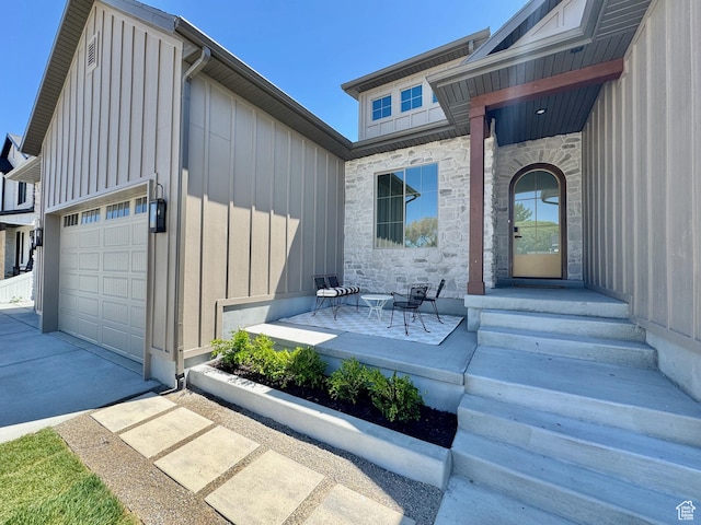 1065 W 125 S, Lehi, UT 84043 - property entrance with board and batten siding, stone siding, concrete driveway, and an attached garage