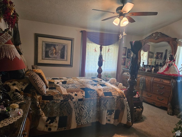bedroom featuring carpet flooring, a ceiling fan, and a textured ceiling