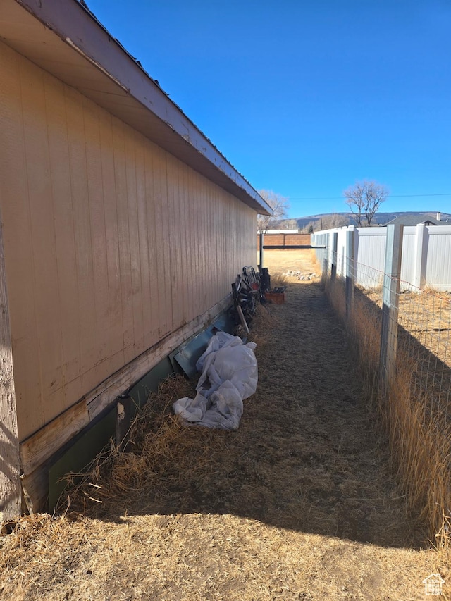 view of side of home with fence