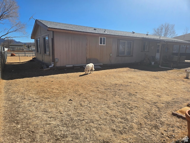 back of house with fence
