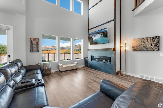 3032 W Cramden Dr, Lehi, UT 84043 - living area with a wealth of natural light, visible vents, wood finished floors, and a glass covered fireplace