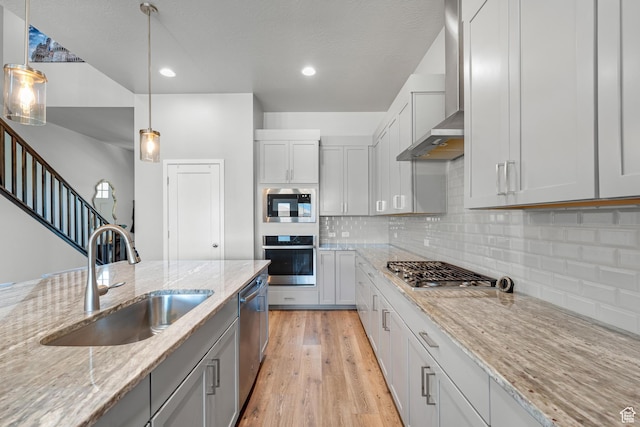 3032 W Cramden Dr, Lehi, UT 84043 - kitchen with a sink, light wood-style flooring, stainless steel appliances, wall chimney range hood, and decorative backsplash