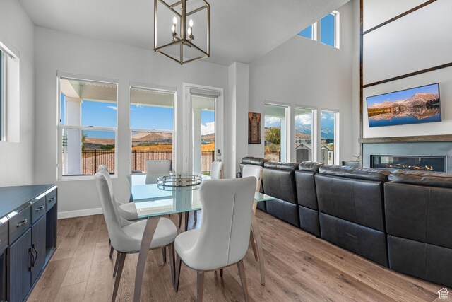 3032 W Cramden Dr, Lehi, UT 84043 - dining area with light wood finished floors, baseboards, a chandelier, and a healthy amount of sunlight