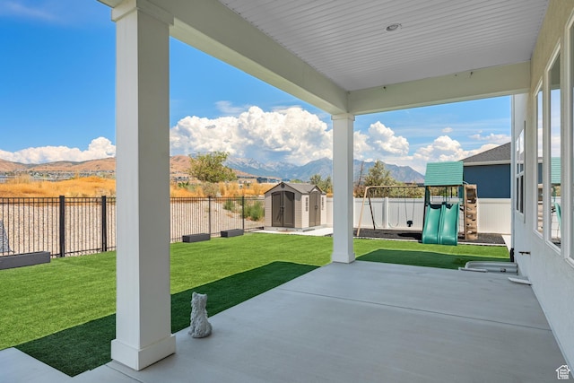 3032 W Cramden Dr, Lehi, UT 84043 - view of patio / terrace featuring a fenced backyard, a shed, an outbuilding, and a mountain view