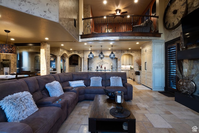 4757 Hidden Lake Dr, Bountiful, UT 84010 - living area featuring ceiling fan, a towering ceiling, recessed lighting, stone tile flooring, and arched walkways