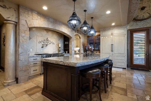 4757 Hidden Lake Dr, Bountiful, UT 84010 - kitchen featuring light stone counters, recessed lighting, a kitchen island, and stone tile floors