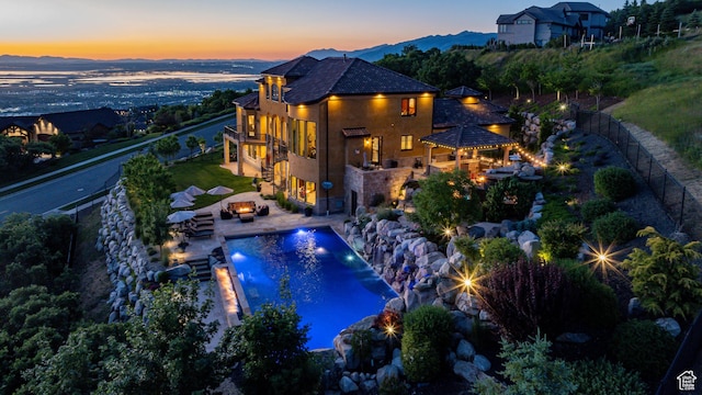 4757 Hidden Lake Dr, Bountiful, UT 84010 - exterior space with a fenced in pool, a fenced backyard, outdoor dry bar, an outdoor living space with a fire pit, and a patio area