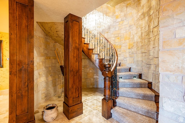 4757 Hidden Lake Dr, Bountiful, UT 84010 - staircase featuring a textured ceiling and a notable chandelier