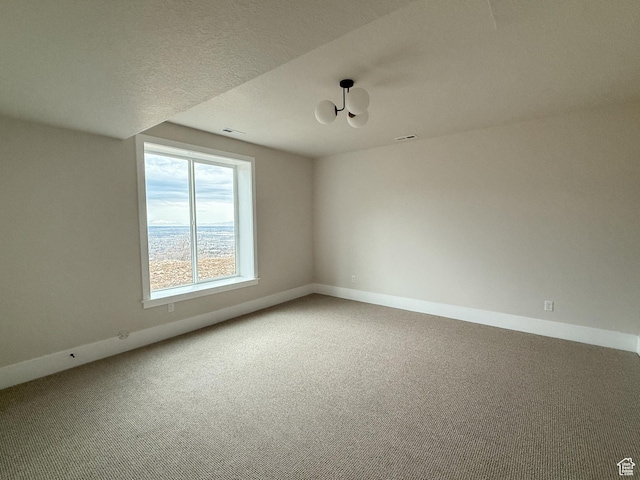 4014 N Dillon Way N, Ogden, UT 84414 - carpeted empty room featuring a notable chandelier, a textured ceiling, baseboards, and visible vents