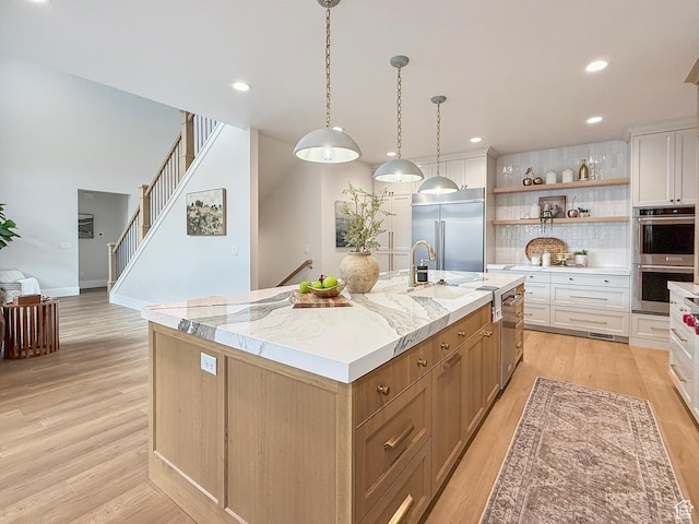 4014 N Dillon Way N, Ogden, UT 84414 - kitchen featuring an island with sink, open shelves, light wood-style floors, and stainless steel appliances
