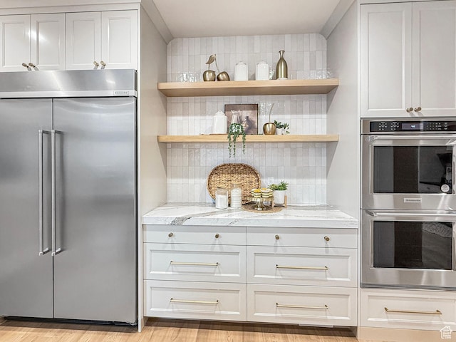 4014 N Dillon Way N, Ogden, UT 84414 - kitchen featuring decorative backsplash, light stone countertops, stainless steel appliances, open shelves, and light wood-style floors