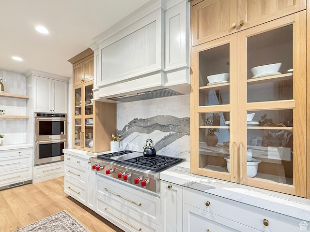 4014 N Dillon Way N, Ogden, UT 84414 - kitchen featuring decorative backsplash, custom exhaust hood, stainless steel appliances, glass insert cabinets, and light wood-type flooring