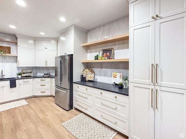 4014 N Dillon Way N, Ogden, UT 84414 - kitchen with light wood-type flooring, freestanding refrigerator, dark countertops, and open shelves