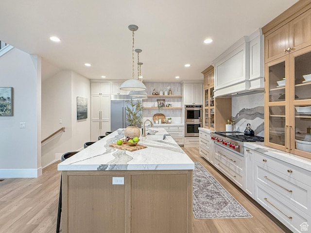 4014 N Dillon Way N, Ogden, UT 84414 - kitchen with stainless steel appliances, an island with sink, a sink, open shelves, and backsplash