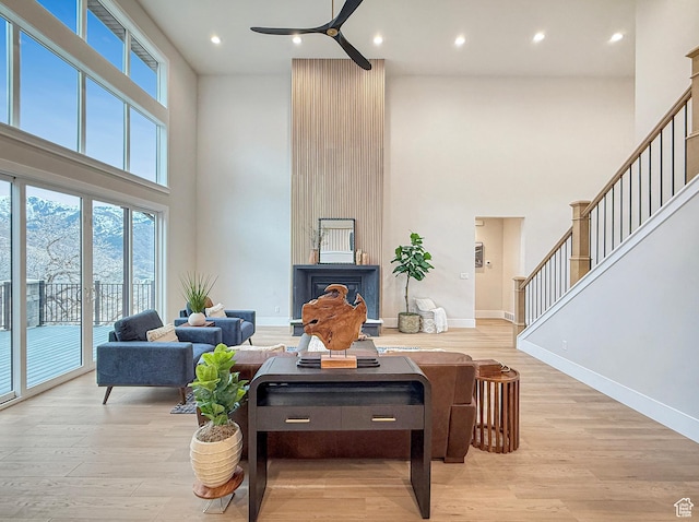 4014 N Dillon Way N, Ogden, UT 84414 - living area with ceiling fan, baseboards, light wood finished floors, and stairs