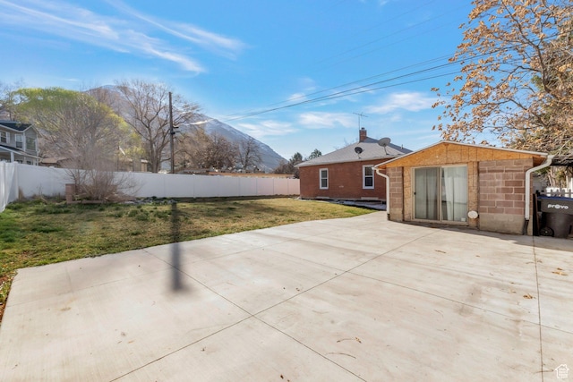 view of patio featuring an outbuilding and fence private yard