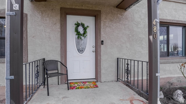 view of exterior entry with stucco siding