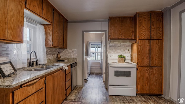 kitchen featuring extractor fan, a sink, a healthy amount of sunlight, and white electric stove