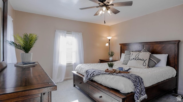 bedroom with light carpet, baseboards, and ceiling fan