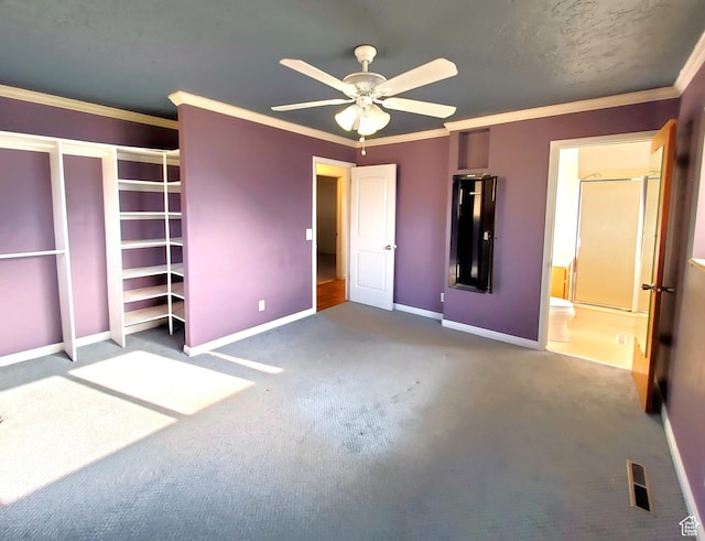unfurnished bedroom featuring carpet flooring, visible vents, baseboards, ornamental molding, and a ceiling fan