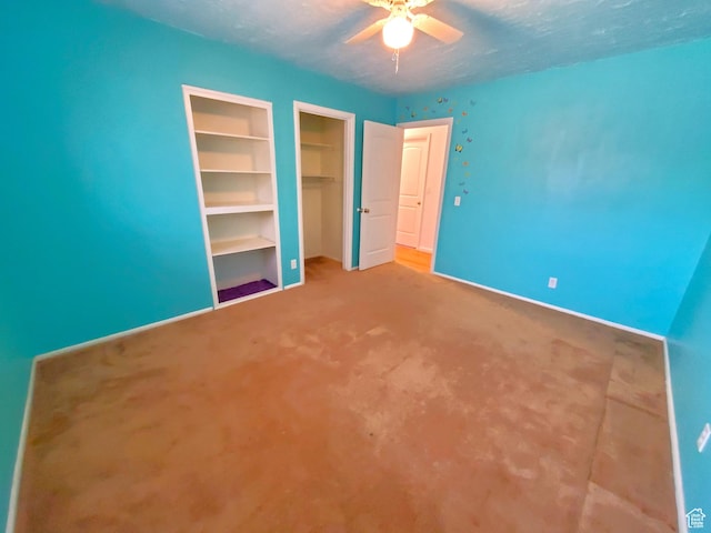 unfurnished bedroom with carpet, ceiling fan, and a textured ceiling