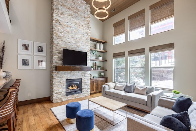 853 W Benjamin Pl, Kamas, UT 84036 - living area featuring baseboards, light wood finished floors, a fireplace, and a towering ceiling