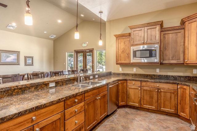 853 W Benjamin Pl, Kamas, UT 84036 - kitchen with a sink, stainless steel appliances, high vaulted ceiling, brown cabinetry, and visible vents