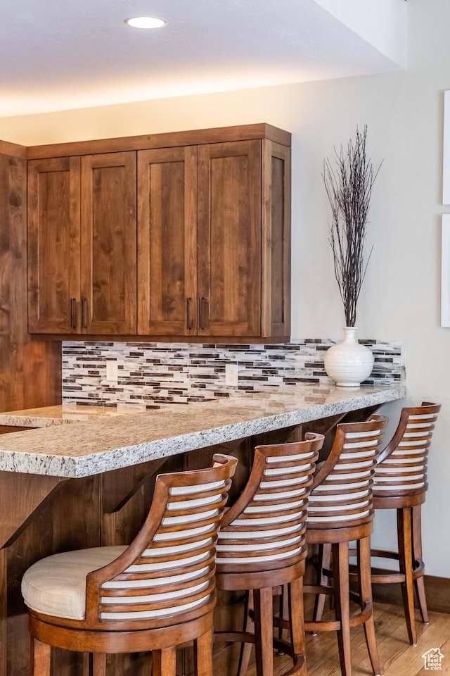 853 W Benjamin Pl, Kamas, UT 84036 - bar featuring a dry bar, wood finished floors, and decorative backsplash