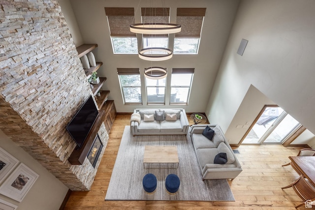 853 W Benjamin Pl, Kamas, UT 84036 - living area with a fireplace, a towering ceiling, and hardwood / wood-style floors