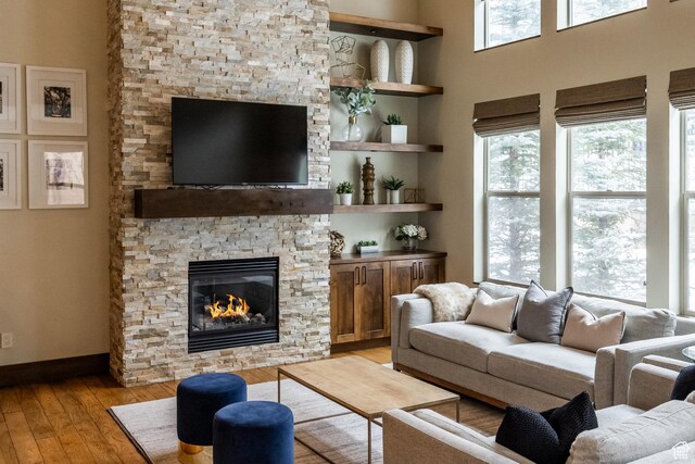 853 W Benjamin Pl, Kamas, UT 84036 - living room with baseboards, a stone fireplace, and light wood-style flooring