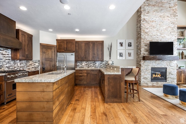 853 W Benjamin Pl, Kamas, UT 84036 - kitchen featuring a sink, open floor plan, light stone countertops, light wood finished floors, and high quality appliances