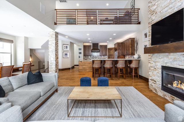 853 W Benjamin Pl, Kamas, UT 84036 - living room featuring baseboards, wood finished floors, a high ceiling, and a fireplace