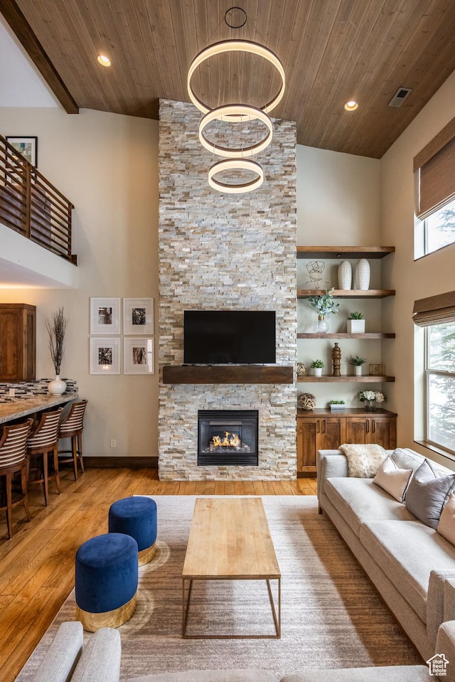 853 W Benjamin Pl, Kamas, UT 84036 - living area featuring light wood finished floors, a high ceiling, a fireplace, visible vents, and wood ceiling