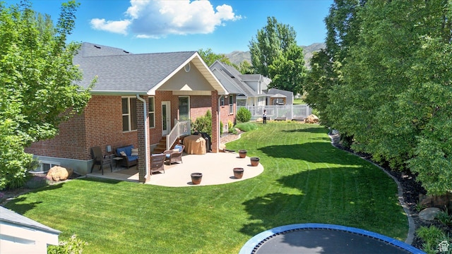 534 E 2000 N, North Logan, UT 84341 - rear view of house with a patio area, brick siding, an outdoor living space, roof with shingles, and a mountain view