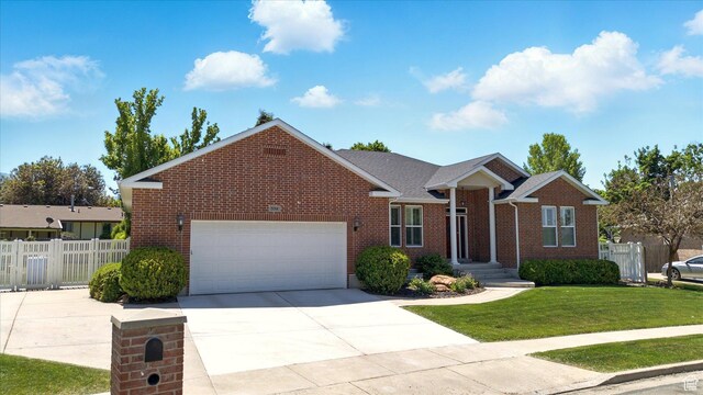 534 E 2000 N, North Logan, UT 84341 - view of front of house featuring brick siding, an attached garage, and driveway