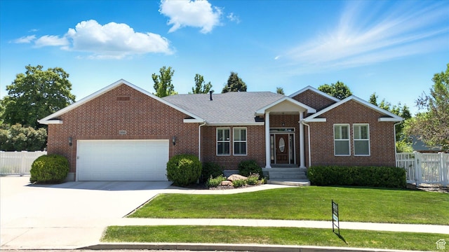 534 E 2000 N, North Logan, UT 84341 - view of front facade featuring brick siding, a garage, and driveway