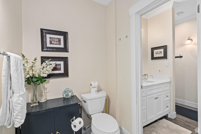 2285 Sidewinder Dr Unit 702, Park City, UT 84060 - bathroom featuring crown molding, baseboards, wood finished floors, toilet, and vanity