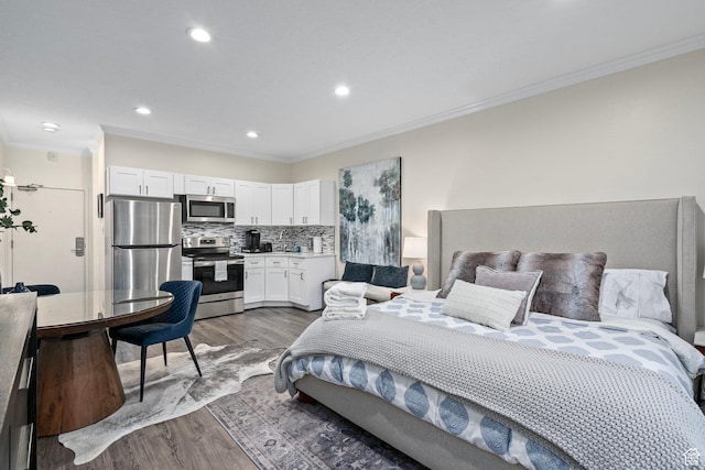 bedroom featuring dark wood-style flooring, crown molding, recessed lighting, and freestanding refrigerator