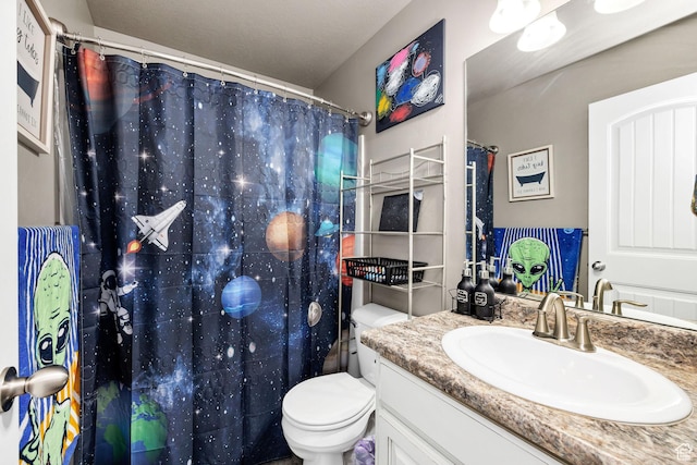 bathroom with toilet, a shower with shower curtain, and vanity