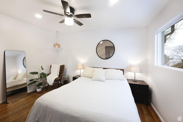 bedroom with dark wood-type flooring, baseboards, and a ceiling fan