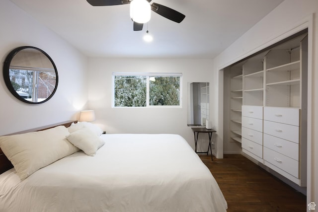 bedroom with dark wood-type flooring and a ceiling fan