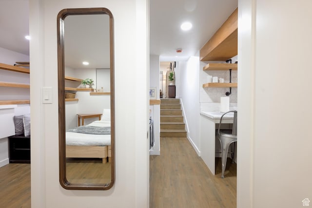 corridor featuring stairway, baseboards, recessed lighting, and wood finished floors