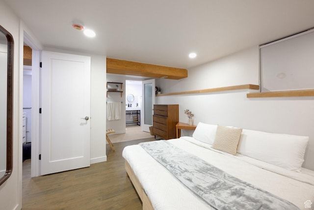 bedroom featuring wood finished floors, baseboards, connected bathroom, and recessed lighting