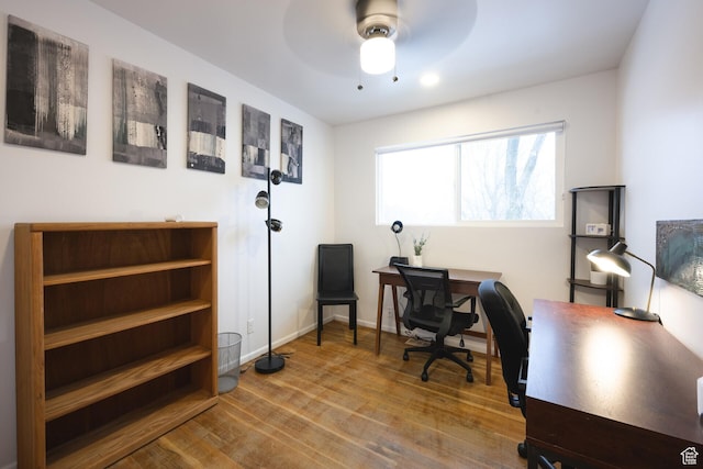 home office with ceiling fan, wood finished floors, and baseboards