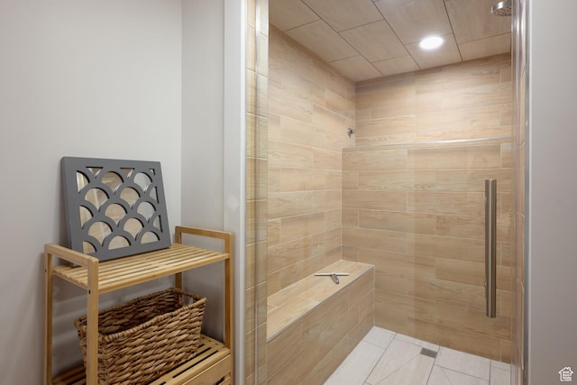 full bath with tile patterned floors and tiled shower