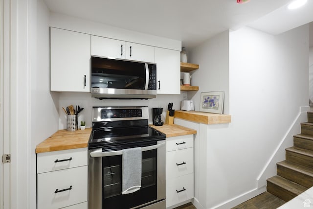 kitchen with white cabinetry, wooden counters, open shelves, and stainless steel appliances