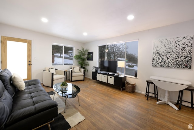 living area featuring wood finished floors, recessed lighting, and a wealth of natural light