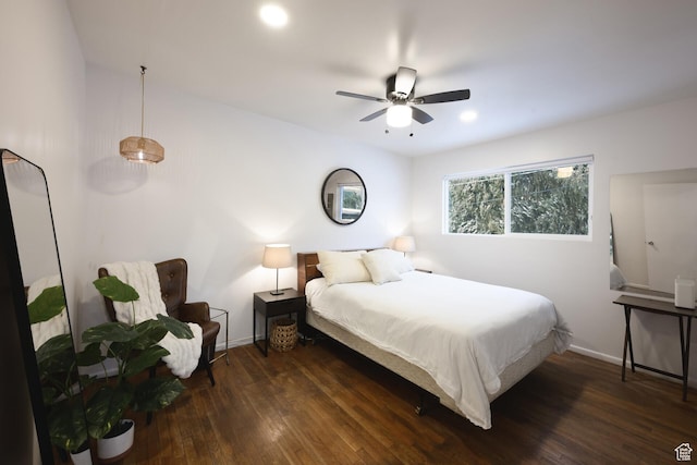 bedroom featuring baseboards, a ceiling fan, and wood finished floors