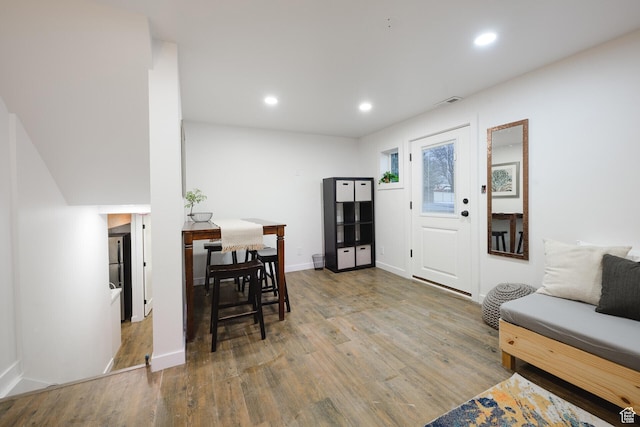 interior space featuring wood finished floors, baseboards, and recessed lighting